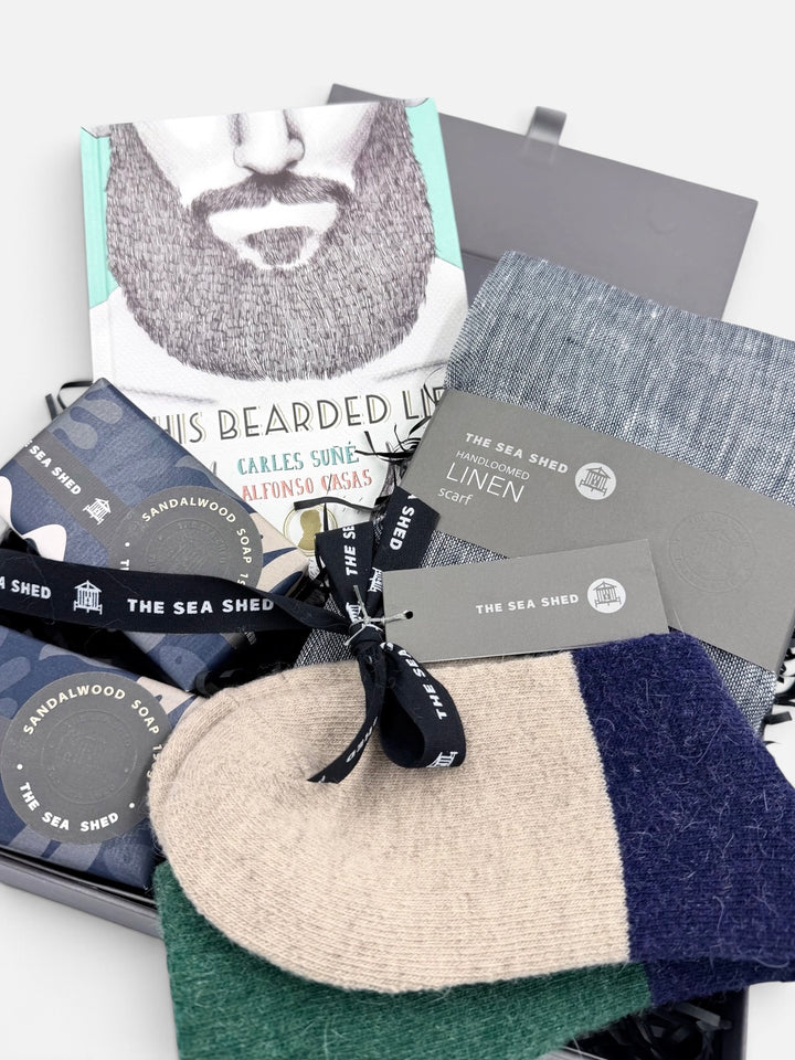 Close-up of the Bearded Life hamper with book, navy linen scarf, Sandalwood soaps and colour-block socks tied with Sea Shed ribbon