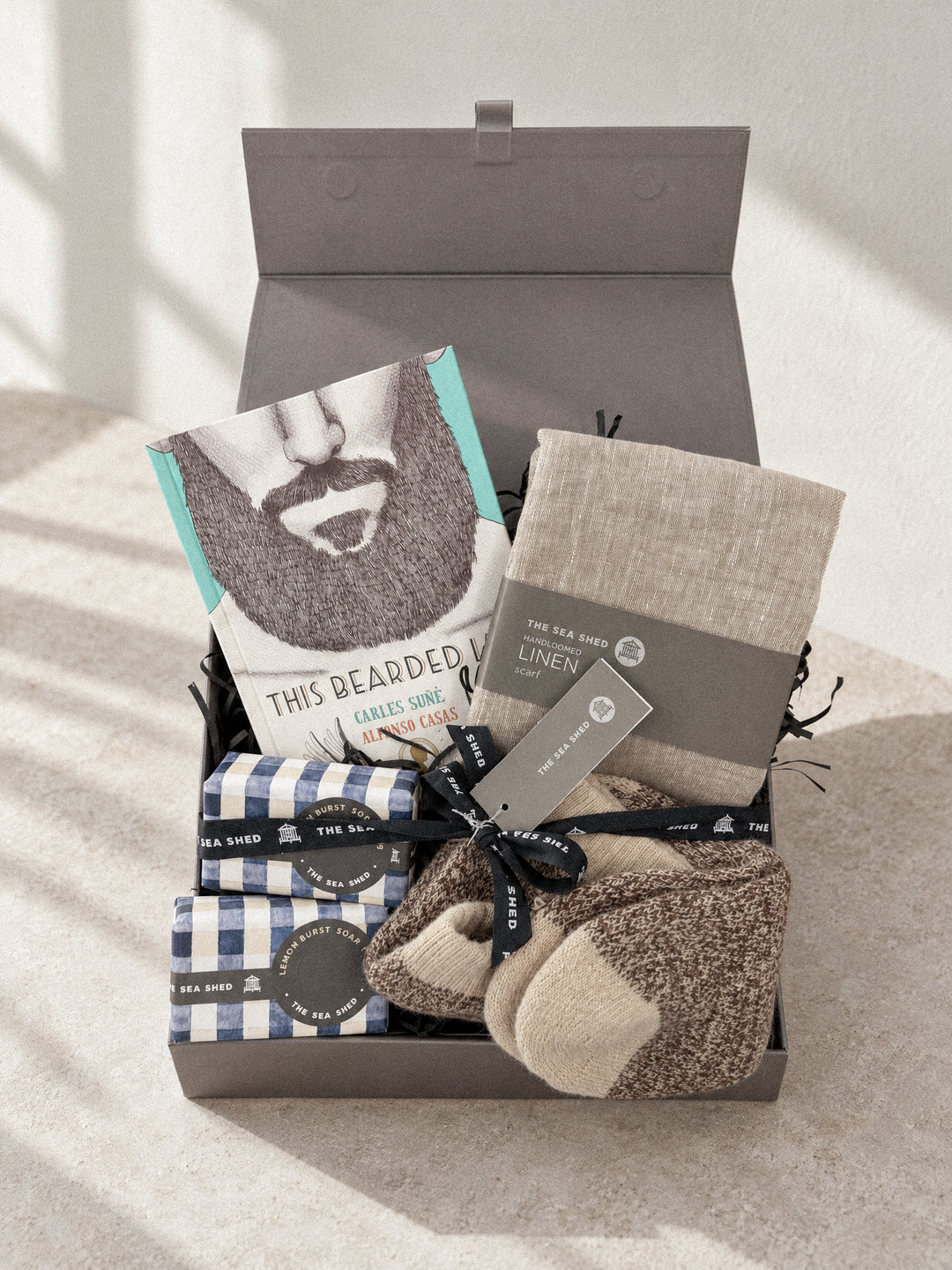 Bearded Life Sand hamper in an open grey keepsake box in soft window light